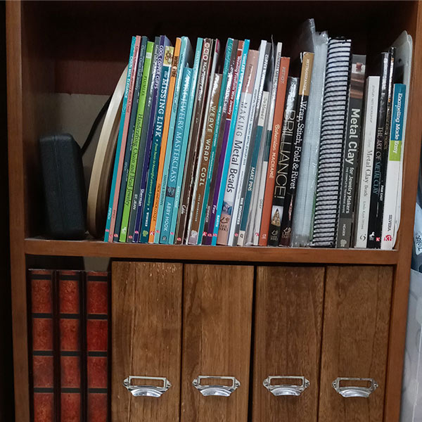 a shelf with books and folders
