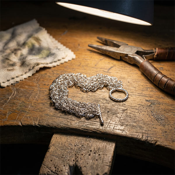 a silver chain on a wooden surface