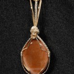 Judy Ellis's Gem Profile- Sunstone - , General Education, , A Sunstone cabochon wrapped  pendant 