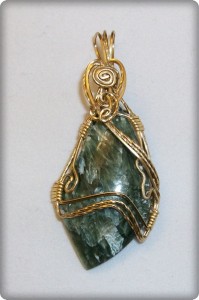 Judy Ellis's Gem Profile- Seraphinite - , General Education, , Freeform seraphinite cabochon in gold-plated wire