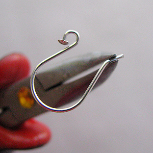 Albina Manning's Nailed Pearl Earrings - , Contemporary Wire Jewelry, Wire Wrapping, Wrapping, Wire Wrapping Jewelry, Chain nose pliers slightly bending the hook of the wire away from the loop.