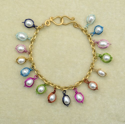 Nancy Chase's Oyster Coast Charm Bracelet, Contemporary Wire Jewelry. Wire Wrapping, Wrapping, Wire Wrapping Jewelry. I designed and wrapped these large holed freshwater pearls to dangle fresh and light from a bold, gold bracelet chain.