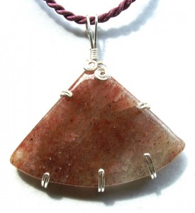 Wire wrapped strawberry quartz cabochon