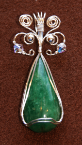 Opaque emerald cabochon wire-wrapped pendant