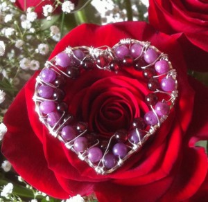 Jane Duke created this lovely heart with sterling silver and ruby and garnet beads.