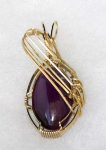 Bonnie DeHart's husband Jerry cabbed this Russian Sugilite, and Bonnie wrapped it into a pendant in 14kt gold-filled wire.