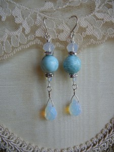 Linda Pope created these Larimar earrings using 12mm Larimar beads, Opalite drops and crystals, crystal spacers, and Sterling Silver wire.